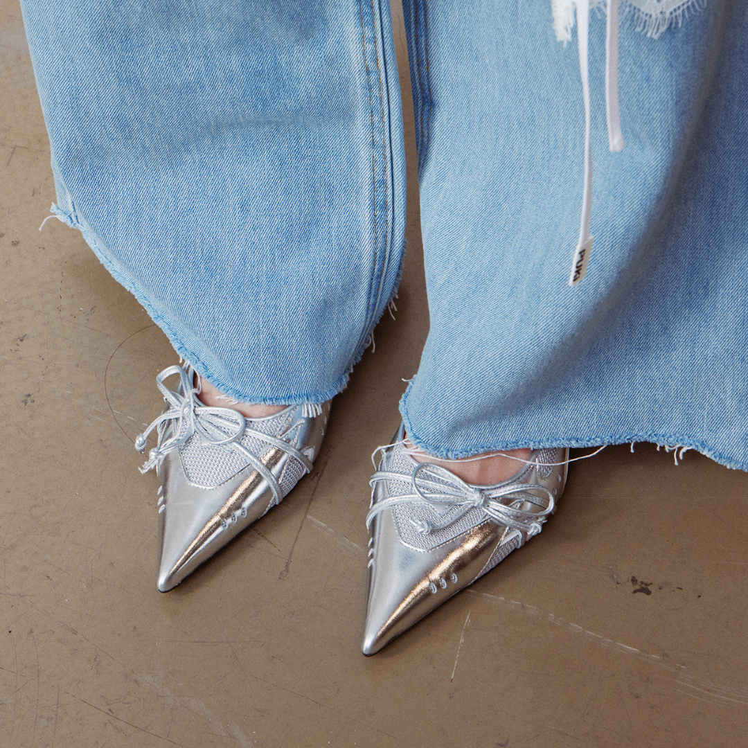 silver low heel pumps worn with denim pants