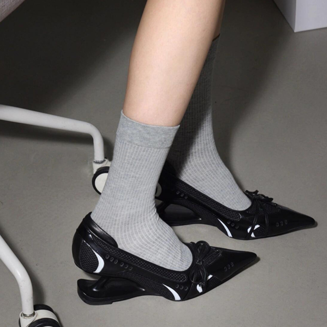 black pointed toe low heel pumps with sculptural heel