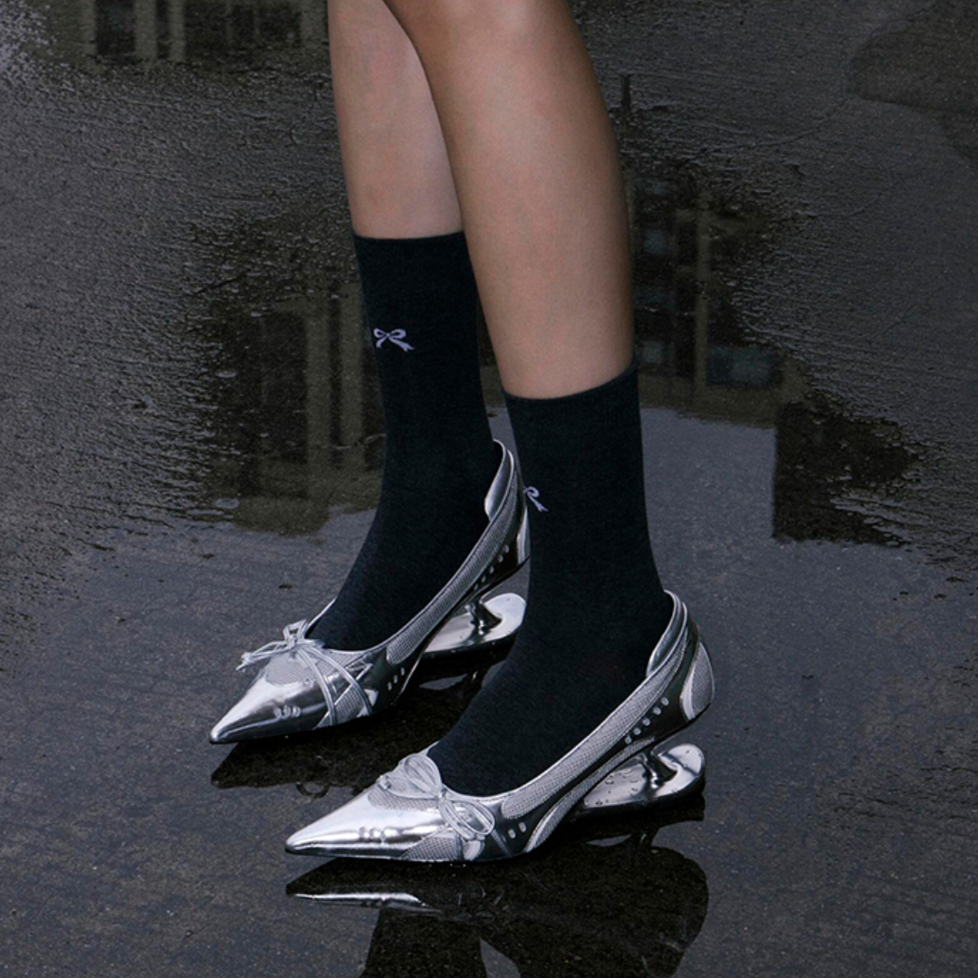 futuristic silver walkable heels worn with black socks outfit styling