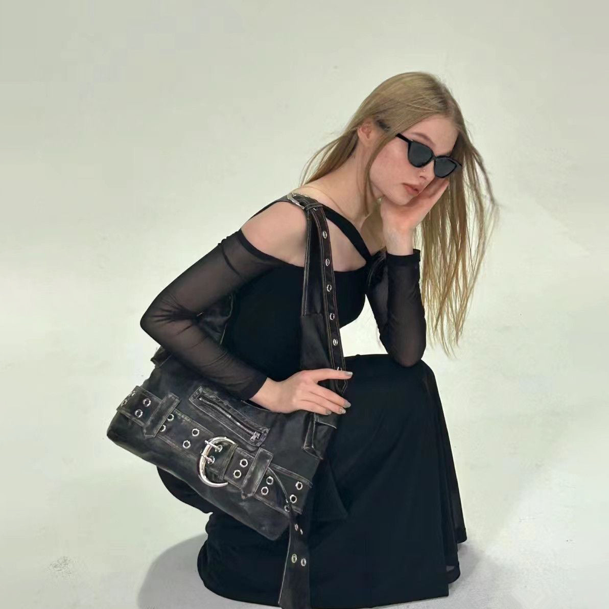 slouchy shoulder bag outfit styling with black dress