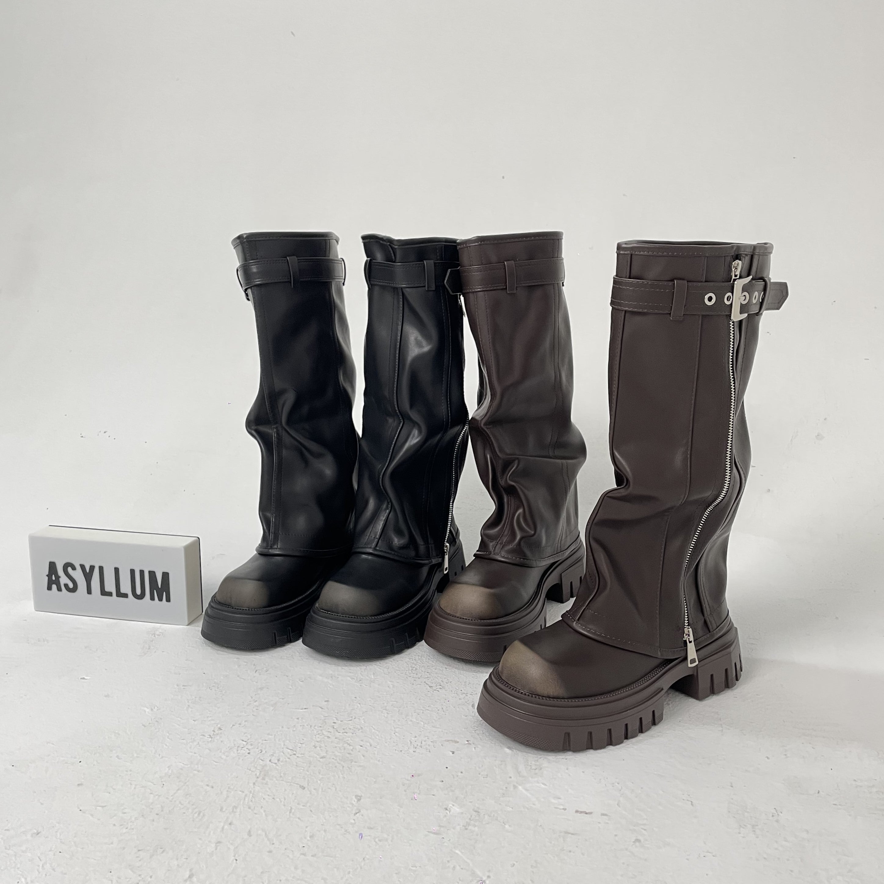 black and brown knee high fold over boots side by side front view

